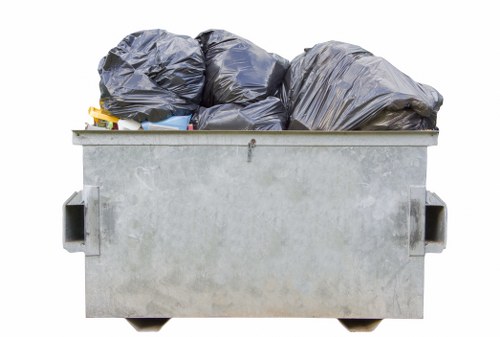 Workers clearing bulky household junk from a London property