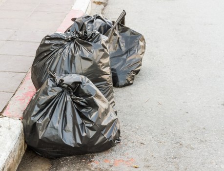 Local rubbish collection team loading waste in London